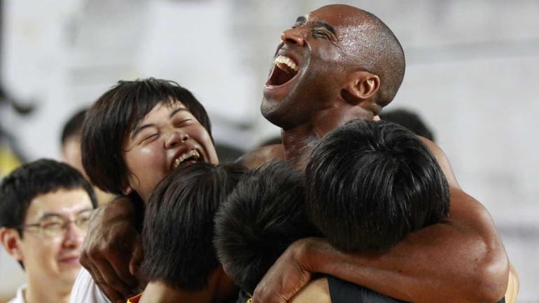 NBA's Los Angeles Lakers Kobe Bryant embraces South Korean students...