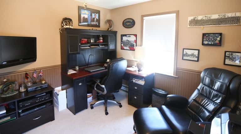 An upstairs bedroom is being used as an office on...