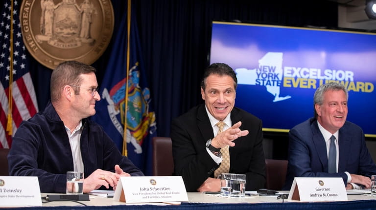New York State Governor Andrew Cuomo, center, makes a remark...