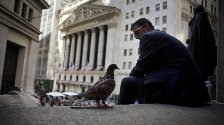 A pigeon stands on the steps of Federal Hall across...
