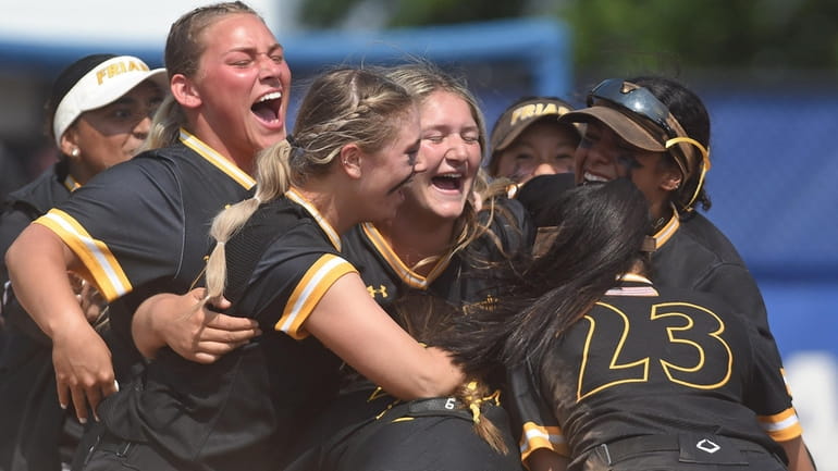 St. Anthony's softball teammates celebrate after their 4-2 win over...