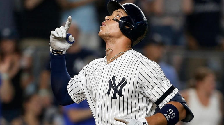 Yankees outfielder Aaron Judge celebrates his eighth-inning two-run home run...