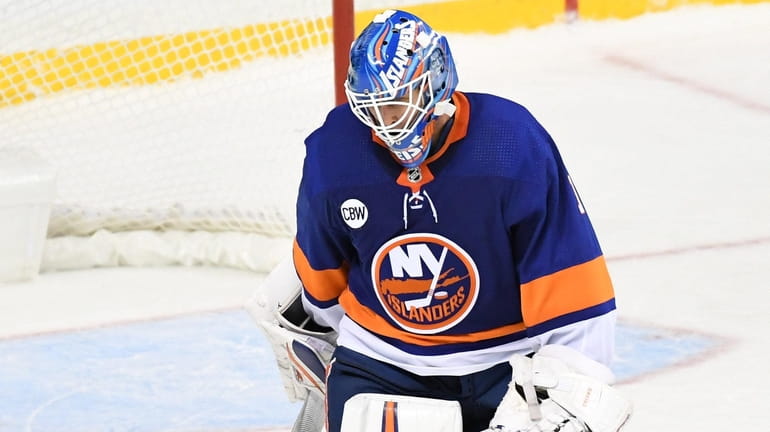 Islanders goaltender Thomas Greiss skates off the ice after Canadiens...