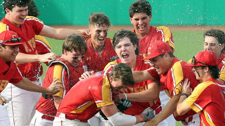 Chaminade’s Nolan Nawrocki (center) is mobbed by teammates after his...