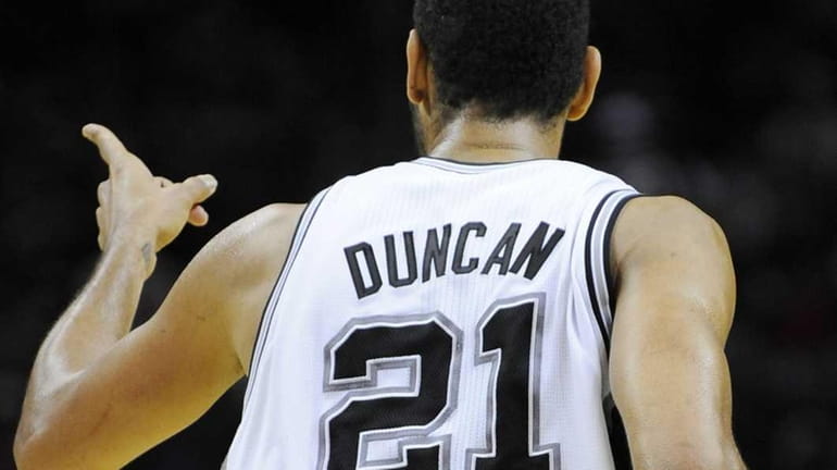 San Antonio Spurs' Tim Duncan gestures after a basket during...