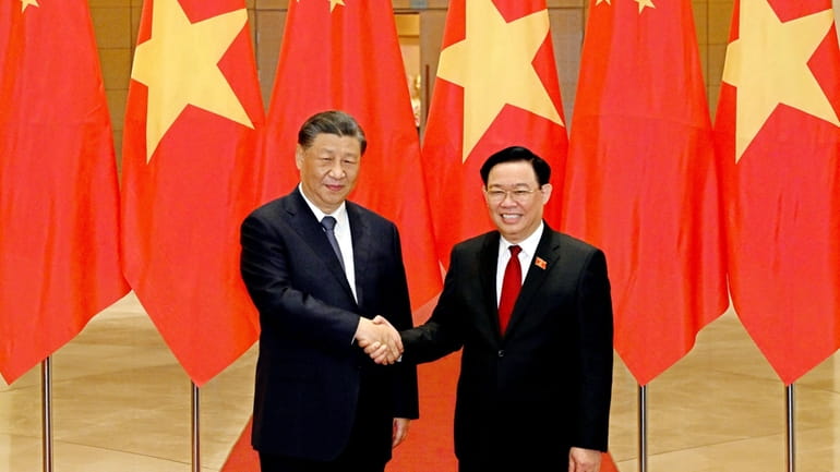 Chinese President Xi Jinping, left, and Vietnamese Chairman of the...