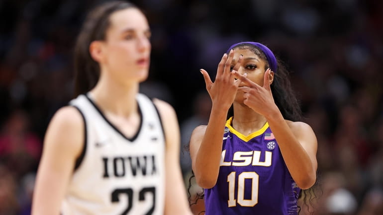 Angel Reese of the LSU Lady Tigers reacts toward Caitlin Clark of...