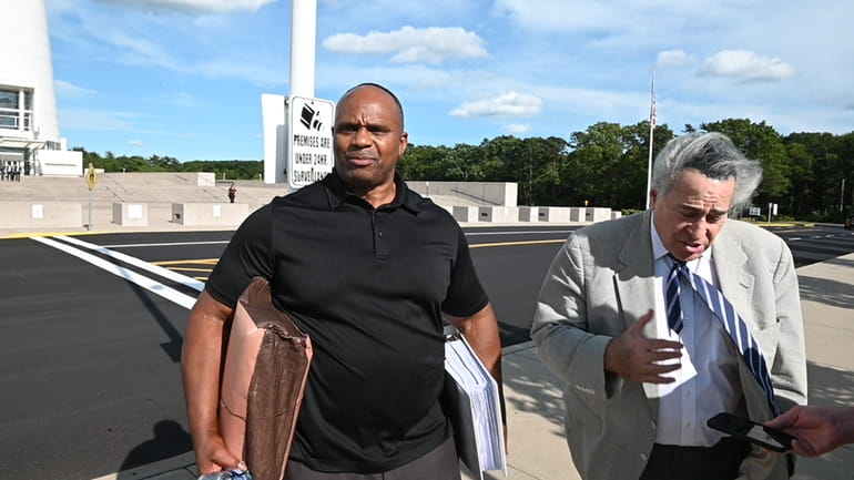 Rickey Lynch, left, walks out of federal court in Central...