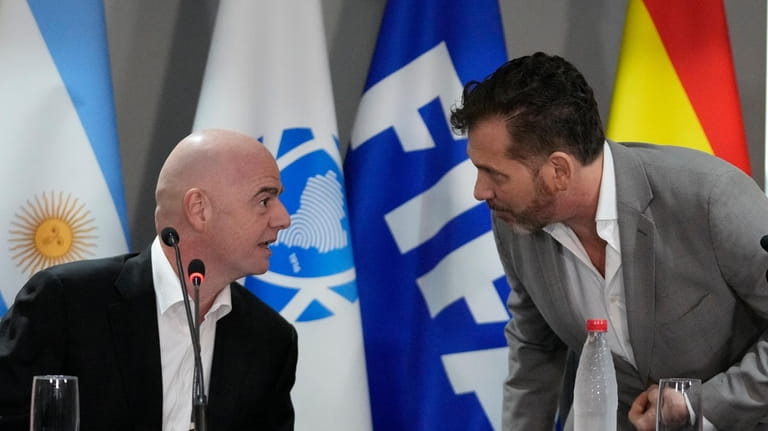 FIFA President Gianni Infantino, left, talks to CONMEBOL President Alejandro...