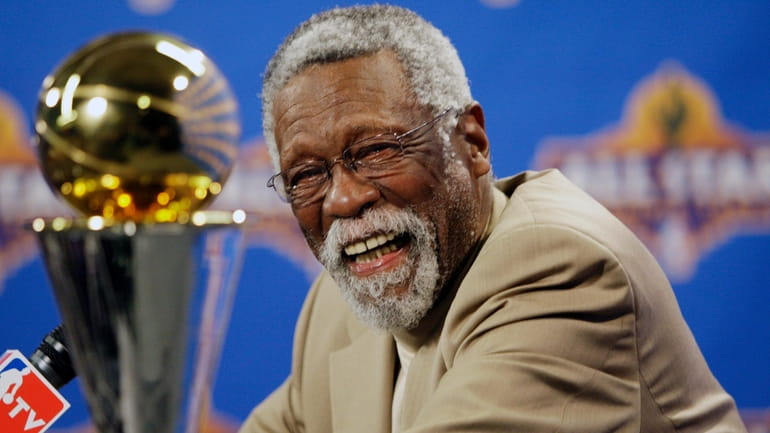 NBA great Bill Russell reacts at a news conference as...