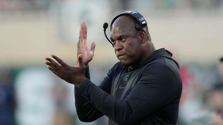 Michigan State head coach Mel Tucker signals from the sideline...