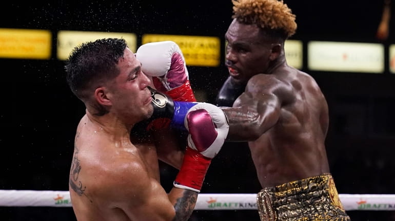 Jermell Charlo, right, lands a shot to Brian Castano during...