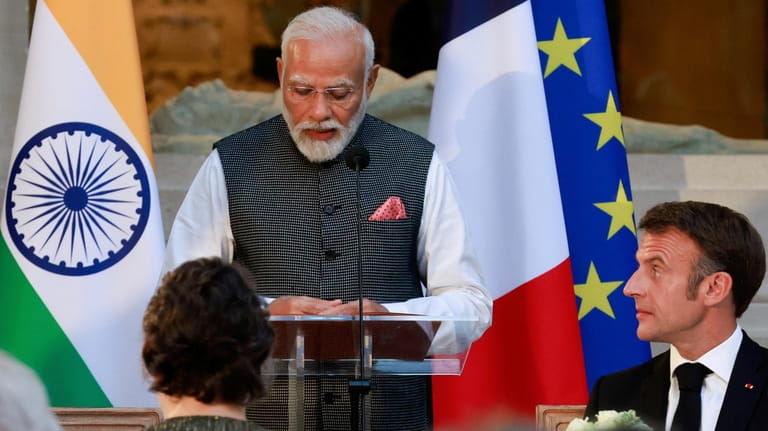 French President Emmanuel Macron, right, listens to Indian Prime Minister...