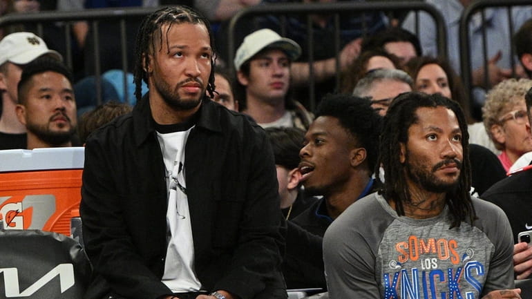 Knicks guard Jalen Brunson, wearing street clothes and not playing...