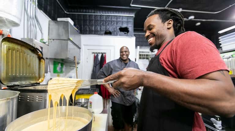 Ford teams with sous chef Andrew McCoy, right, to make...