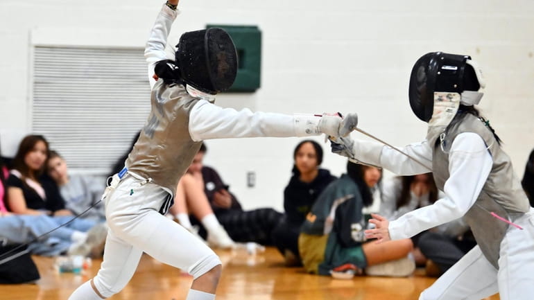 Sophie Chen of Newfield ,left, competes in the girls foil...