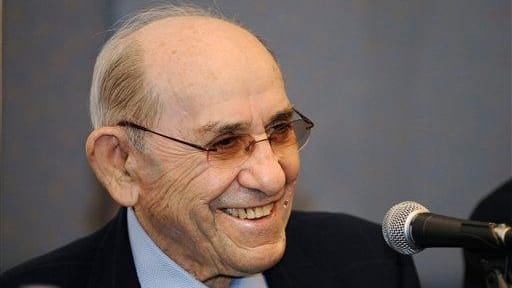 Yankees Hall of Famer Yogi Berra smiles during a news...