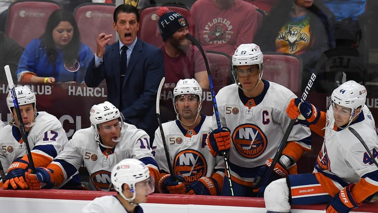 New York Islanders' coach Lane Lambert shouts instructions to his...