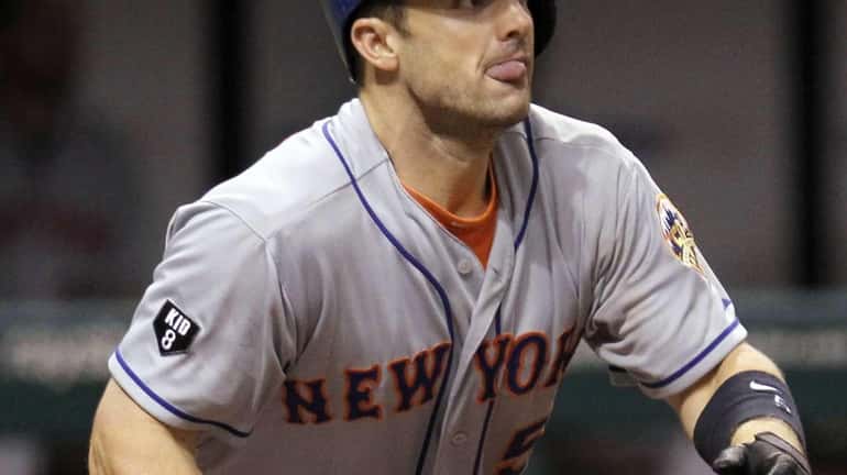 New York Mets' David Wright reacts as he follows the...