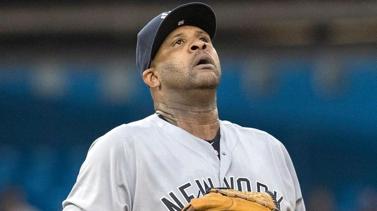 Yankees pitcher CC Sabathia reacts after giving up a second...
