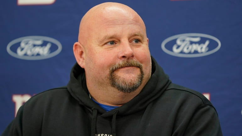 Giants head coach Brian Daboll smiles during a news conference...