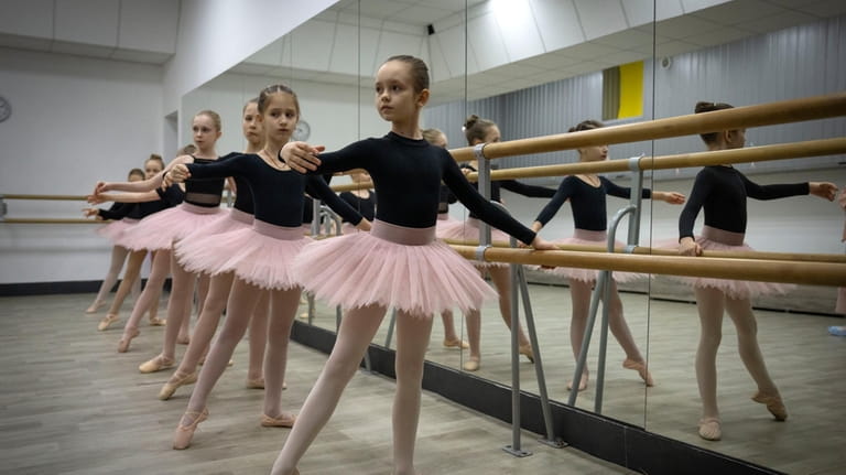 Girls practice in a ballet studio in a bomb shelter...