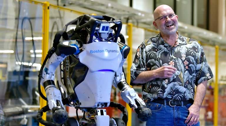 Marc Raibert, founder and chair of Boston Dynamics with one of...