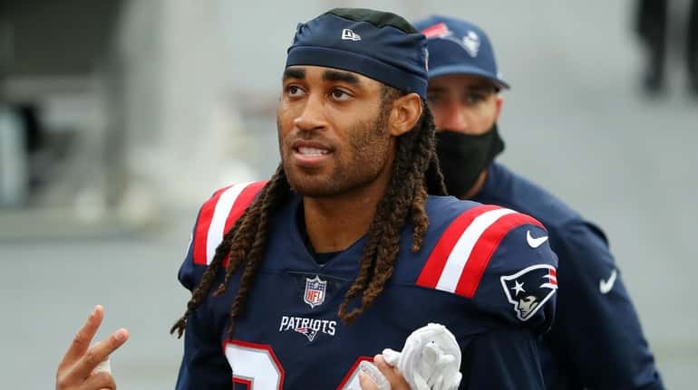 Stephon Gilmore #24 of the New England Patriots reacts after...