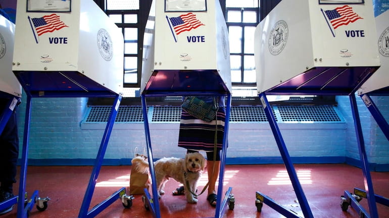 A woman casts vote at a polling station in Brooklyn...