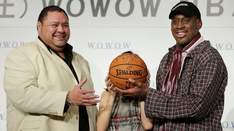 Former NBA basketball player Dennis Rodman, right, former sumo grand...