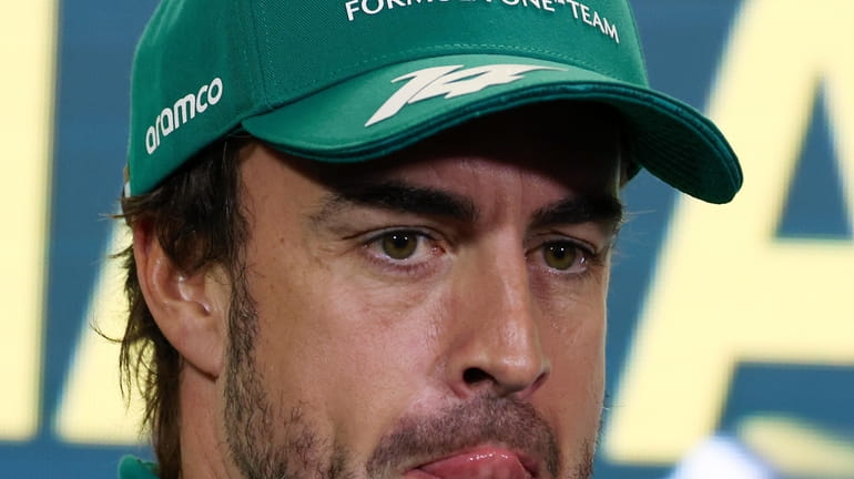 Aston Martin driver Fernando Alonso of Spain attends a press...