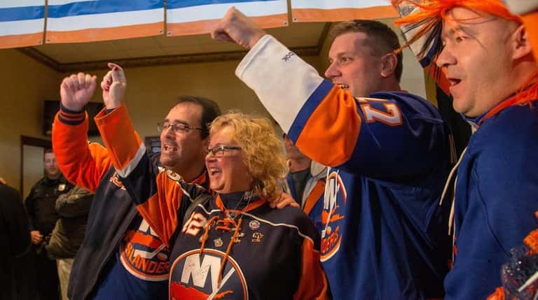 From left, New York Islander fans Gary and Claire Harding,...