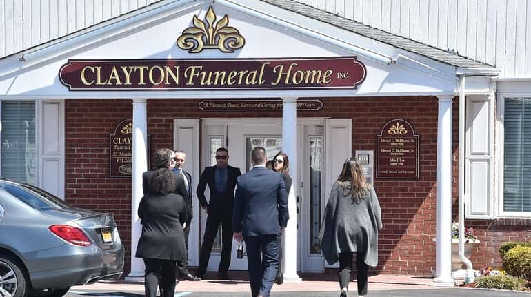 Mourners arrive at funeral services Wednesday for former Smithtown Town...