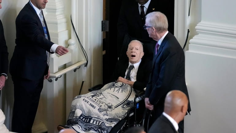 Former President Jimmy Carter, arrives to attend a tribute service...