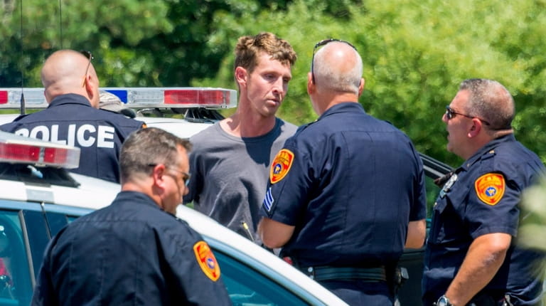 Keith Clancy, 32, is taken into custody Sunday after he...