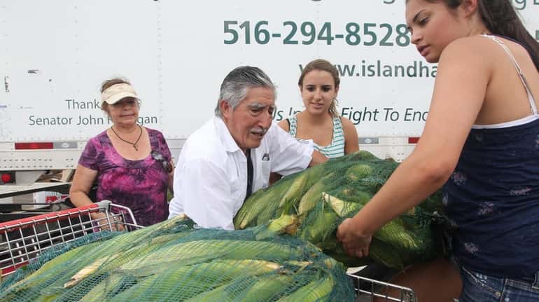 Alfonso Paredes of God Provisions in Central Islip helps volunteer...