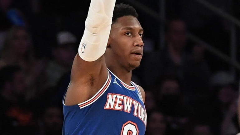 Knicks guard RJ Barrett gestures after scoring a three-point basket...