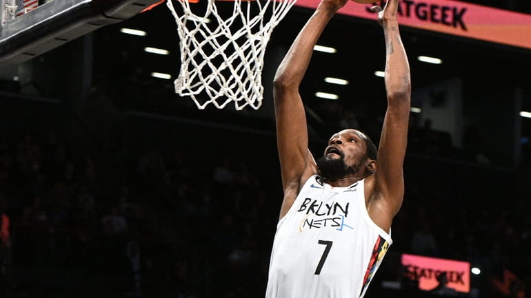 Brooklyn Nets forward Kevin Durant dunks in front of Charlotte...