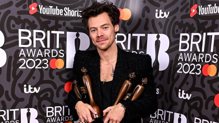 Harry Styles poses with the trophies for pop/R&B act, artist...