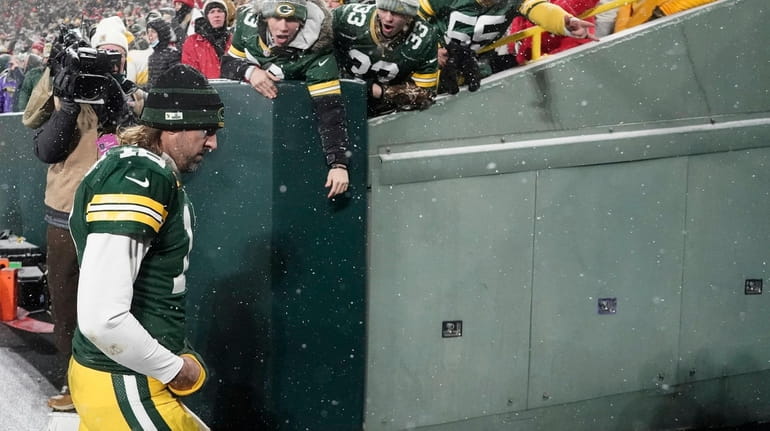 The Packers' Aaron Rodgers leaves the field after an NFC...