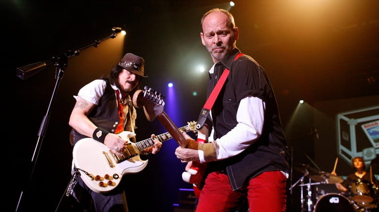 Guitarist Wayne Kramer of The MC5, right, performs together with...