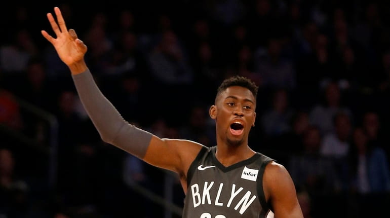 The Nets' Caris LeVert reacts after teammate D'Angelo Russell scored a...