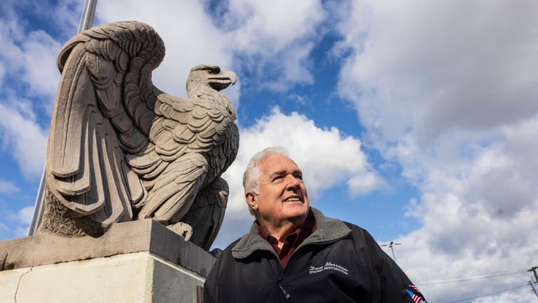 David D. Morrison poses with an eagle at the Hicksville...