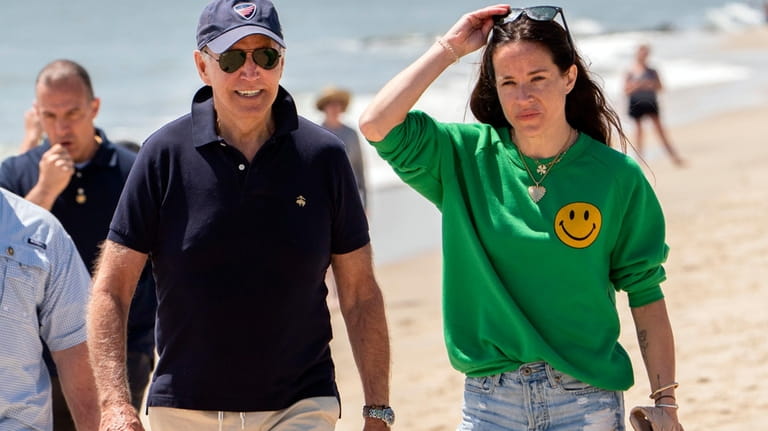President Joe Biden walks on the beach with daughter Ashley...