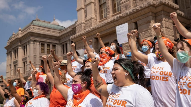 Women protest the new abortion law at the Capitol in Austin,...