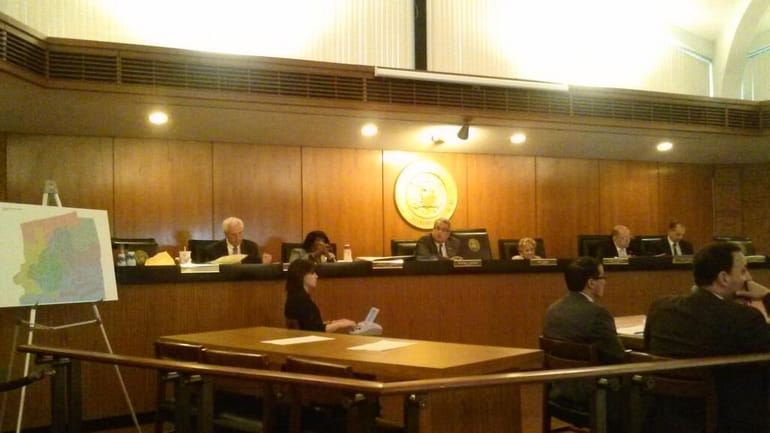 The Hempstead Town board listens to speakers during redistricting public...