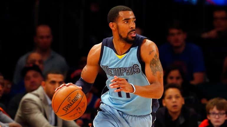 Mike Conley Jr. of the Memphis Grizzlies controls the ball...