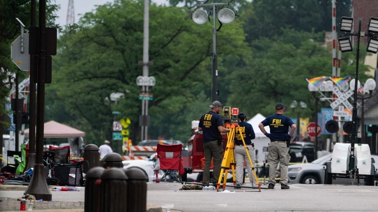 FBI agents work the scene of the July 4 mass shooting...