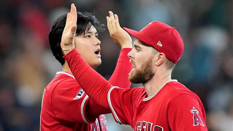Los Angeles Angels' Shohei Ohtani, left, and Jared Walsh celebrate...