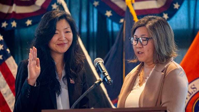 Town of North Hempstead Councilwoman Christine Liu, left, takes her...